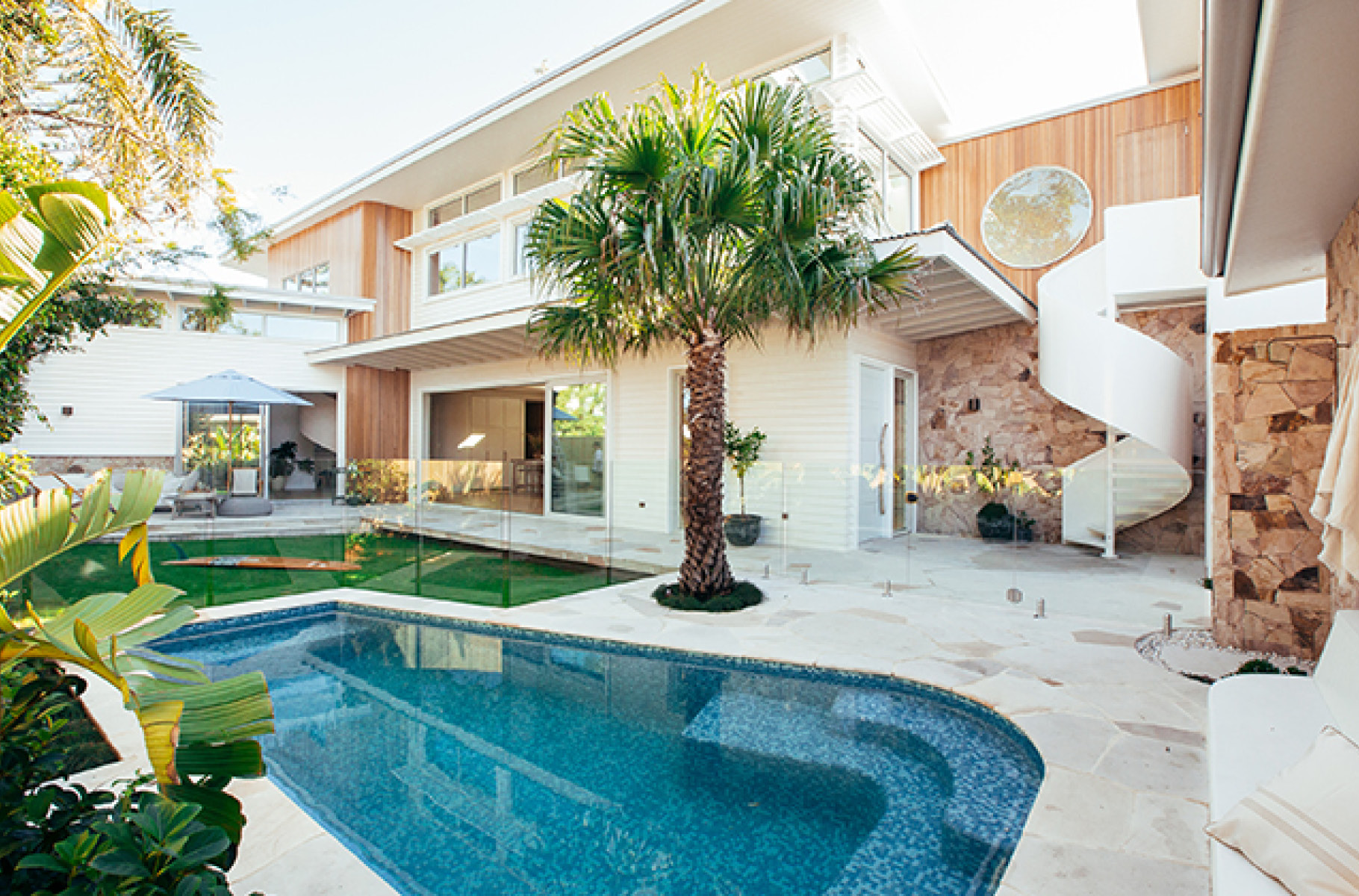 Pictured: Pool and garden area with spiral staircase leading to the parents retreat and home office Pictured: Pool and garden area with spiral staircase leading to the parents retreat and home office
